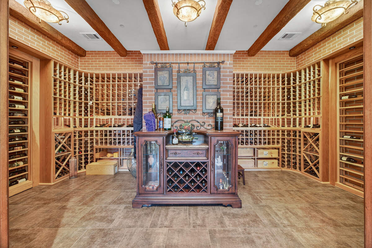 The wine cellar includes doors carved in Monterrey, Mexico, and has capacity for about 2,300 bottles, one of many custom and salvaged details throughout the estate.
